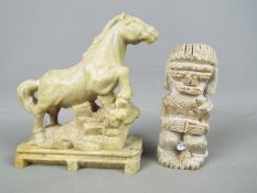 A stone carving depicting a horse, raised on plinth (approximately 16 cm height) and one further.