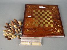 Chess Set - A carved wood chess set with brass inlay and combined backgammon board and counters,