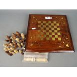 Chess Set - A carved wood chess set with brass inlay and combined backgammon board and counters,