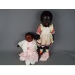 A pair of black Americana dolls, a black female doll with jointed arms, legs,