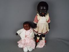 A pair of black Americana dolls, a black female doll with jointed arms, legs,