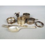 A collection of hallmarked silver items to include napkin rings, cutlery,