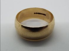 A hallmarked 9ct yellow gold wedding band, size S, approximately 6.3 grams all in.