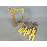 A art nouveau style picture frame and a quantity of fish knives and folks