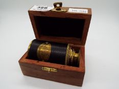 A boxed brass and leather telescope