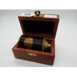 A boxed brass and leather telescope