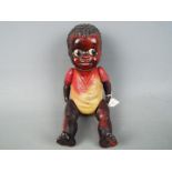 Celluloid Doll - a string jointed black Americana boy doll with black textured hair and kewpie eyes