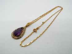 A 9ct gold, amethyst and pearl pendant on a 9ct gold paper link chain (44 cm length),