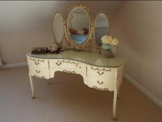 A cream painted kidney shaped dressing table in the French style,