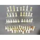 Chess Set - Two sets of carved onyx chess pieces,