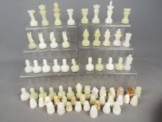 Chess Set - Two sets of carved onyx chess pieces,