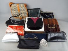 A quantity of lady's handbags including a snake skin example.