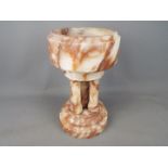 A marble holy water font,