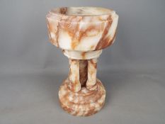 A marble holy water font,