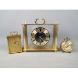 Three clocks comprising a German travelling alarm clock,