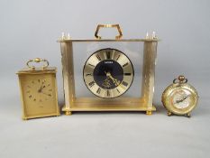 Three clocks comprising a German travelling alarm clock,