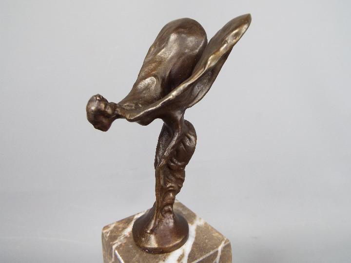 A bronzed flying lady in the form of Spirit of Ecstasy set on a marble plinth, - Image 2 of 3