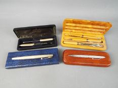 A small collection of pens including Sheaffer fountain with 14k nib,