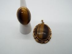 A 9ct gold and tigers eye ring having large cabochon tigers eye (approximately 2.