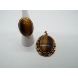 A 9ct gold and tigers eye ring having large cabochon tigers eye (approximately 2.