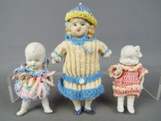 Bisque Dolls - a collection of bisque dolls to include a boy doll with jointed arms and legs marked