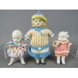 Bisque Dolls - a collection of bisque dolls to include a boy doll with jointed arms and legs marked