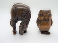 Two Japanese carved wood netsuke, one in the form of an owl, the other a grazing horse, both signed.