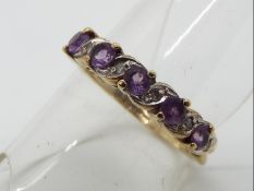 A 9 carat gold ring set with amethyst and diamonds,