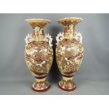 A pair of large twin handled vase of baluster form with moriage decoration depicting samurai in a