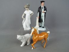 A Royal Doulton figurine 'The Graduate' # HN3017, a Beswick palomino horse,