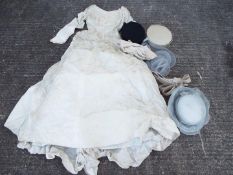 A vintage Laura Phillips wedding dress and a quantity of lady's hats contained in a hat box.