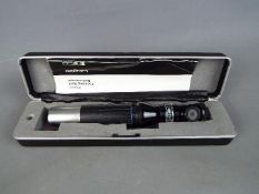 A cased Keeler Focusing Spot Retinoscope.