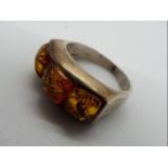 A silver dress ring set with Amber, size O and a half,