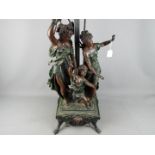 A large three light table lamp decorated with classical figures,