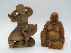 Two Oriental soapstone carvings, one depicting the Laughing Buddha, largest approximately 10 cm (h).