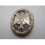 A white metal brooch displaying an eagle