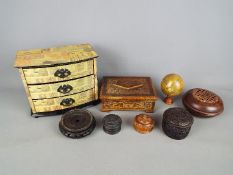 A collection of treen, carved wooden trinket boxes and similar.