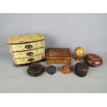 A collection of treen, carved wooden trinket boxes and similar.