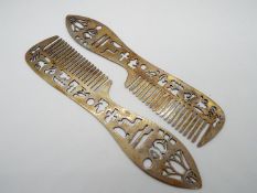 A pair of Egyptian combs decorated with hieroglyphics and other marks, stamped,