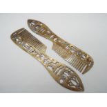 A pair of Egyptian combs decorated with hieroglyphics and other marks, stamped,