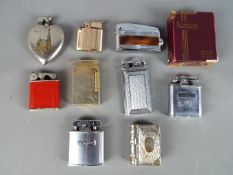 A collection of vintage cigarette lighters and plated vesta case in the form of a book.