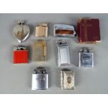 A collection of vintage cigarette lighters and plated vesta case in the form of a book.