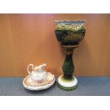 A jardiniere and stand with a wash bowl and jug.
