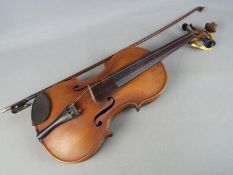 A violin and bow, the violin body 36 cm (length) Condition Report: Appears in good condition,