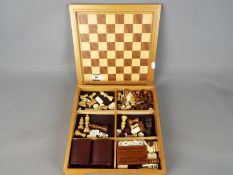 Chess Set - A chess set with reversible board for backgammon, with chess pieces,