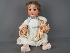 Heubach Koppelsdorf - a girl doll with ceramic face, painted eyebrows and lashes,
