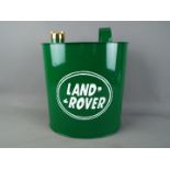 A reproduction 'Land Rover' petrol can, in green, with brass cap, approximately 34 cm (h).