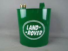 A reproduction 'Land Rover' petrol can, in green, with brass cap, approximately 34 cm (h).