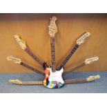 An interesting sculpture formed from a guitar and guitar parts to give the impression of a 7 necked