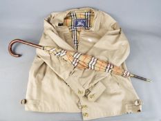 A gentleman's 'Harrington' jacket, marked 'Burberry's' size Regular-18 and a similar umbrella.